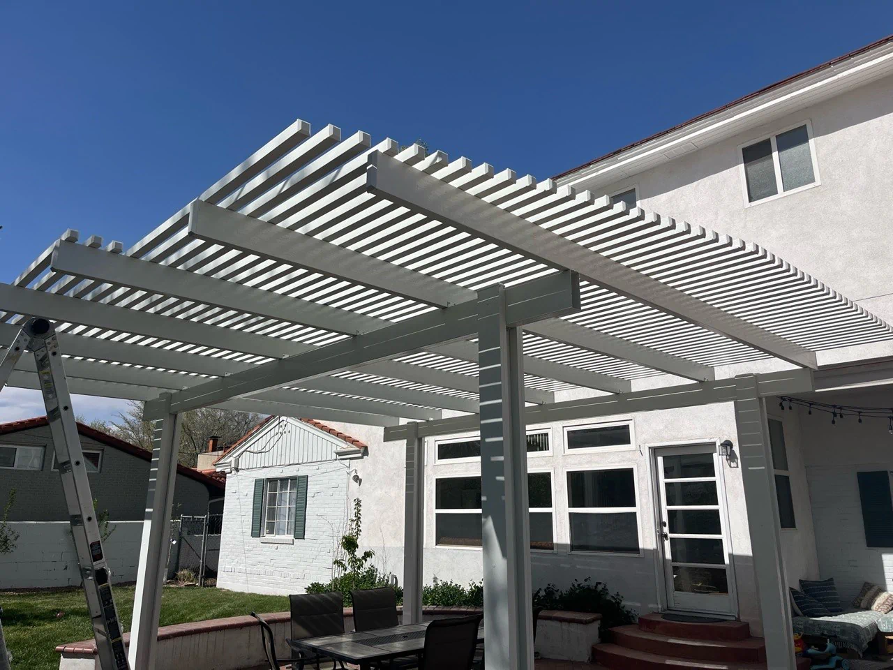 Flat pan aluminum patio cover with insulated roofing over a patio in Albuquerque