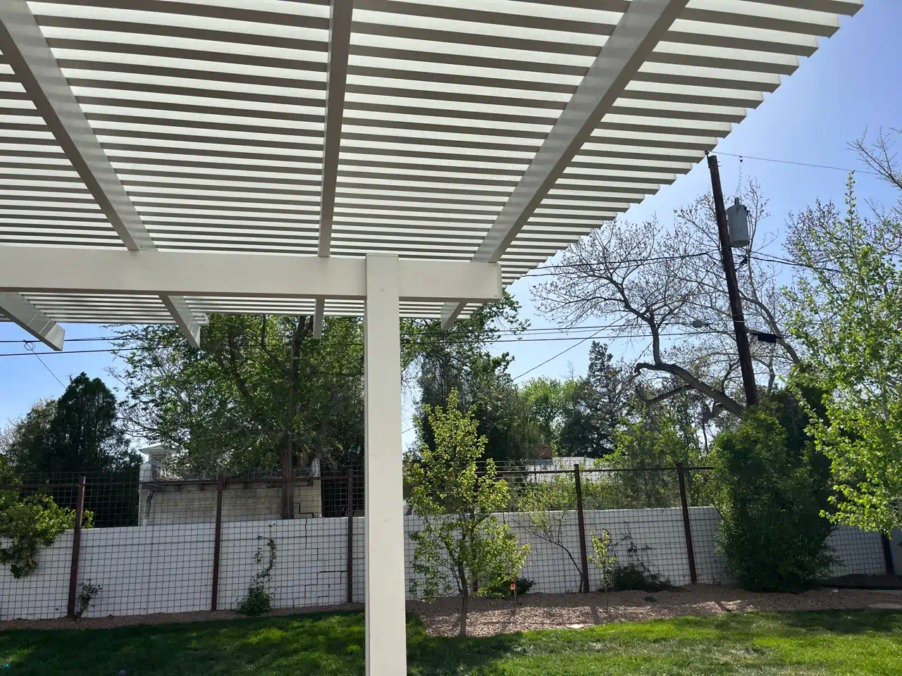 Aluminum flat pan patio cover attached to a stucco home in Albuquerque, NM
