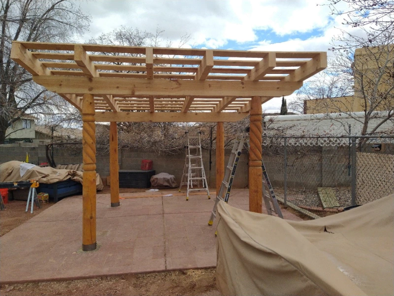 Cedar wood pergola shading an outdoor dining area in Albuquerque