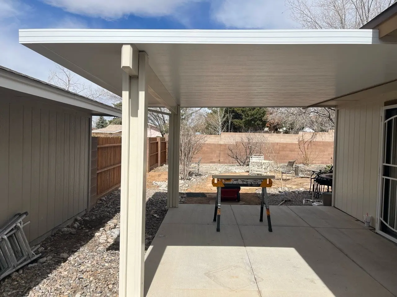 Custom aluminum patio cover installed over a paved patio in Albuquerque