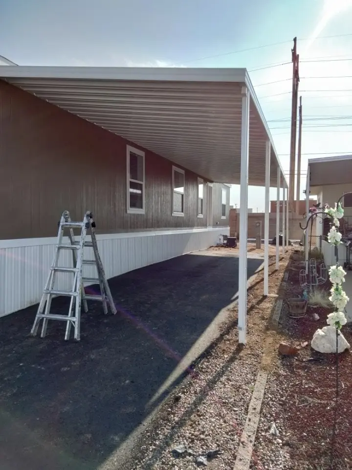 Freestanding aluminum patio cover shading an outdoor seating area in Rio Rancho
