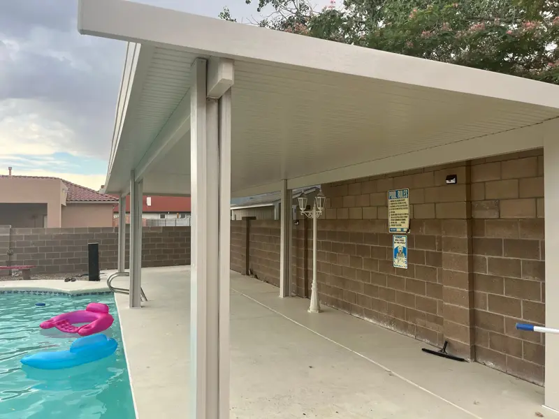 Aluminum patio cover protecting a back patio from the New Mexico sun