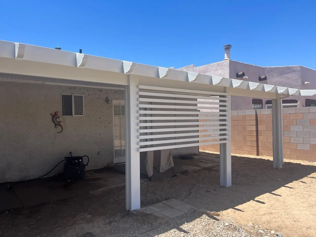 Large aluminum patio cover spanning a backyard entertaining space in Albuquerque